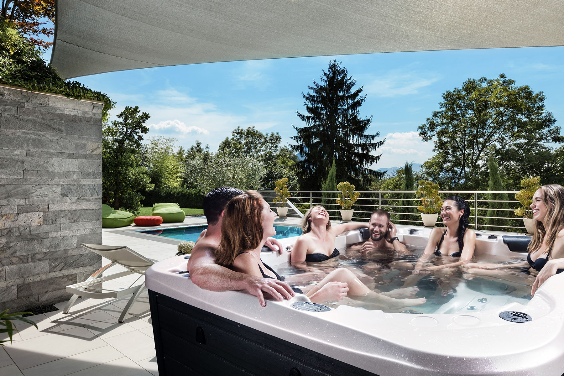 A couple enjoying hot tub with friends