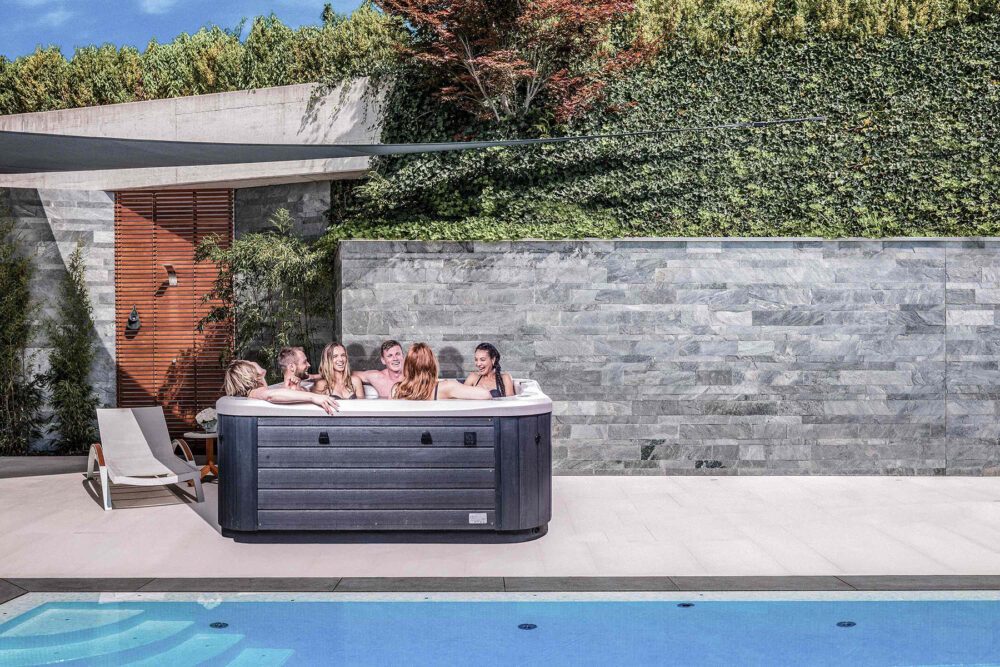 Friends enjoying hot tub by the pool