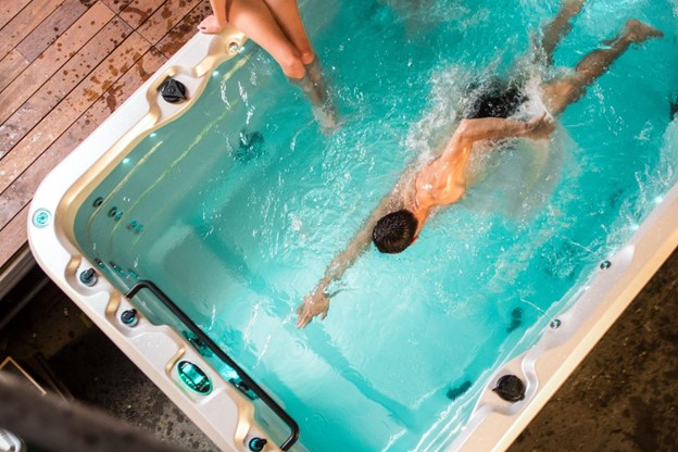 Man swimming in a swim spa